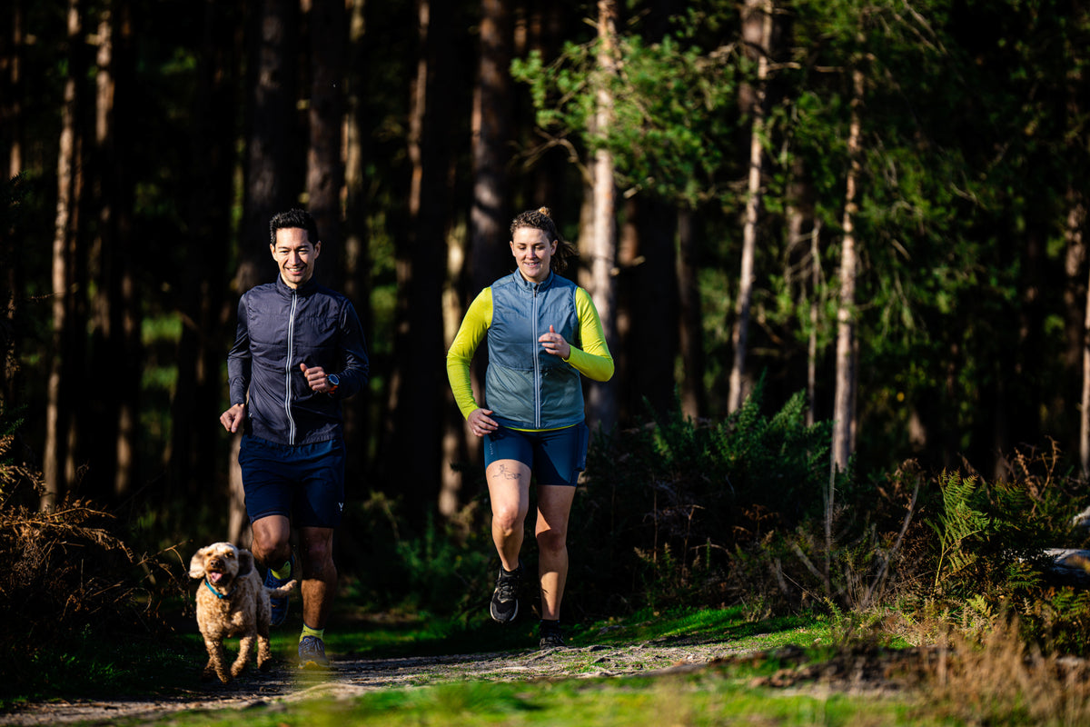 Two runners in gilets