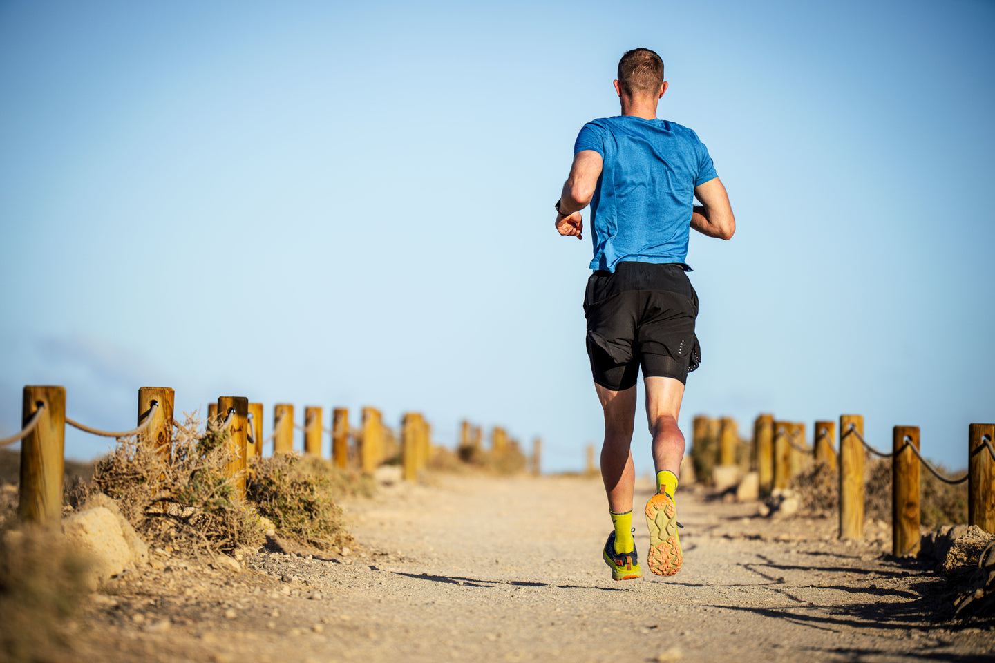 Man running on a sandy trail