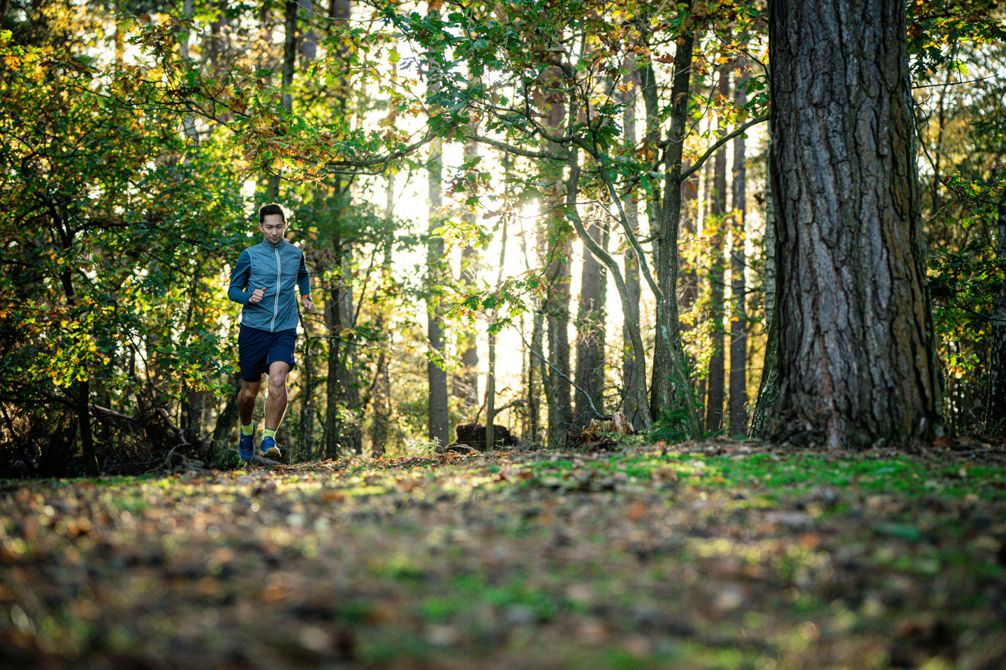 Man running wearing a blue gilet