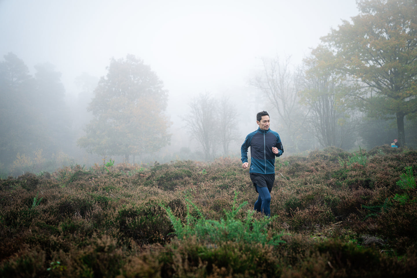 Man running through a foggy forest