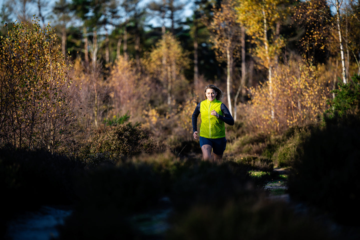 Women running wearing a green gilet