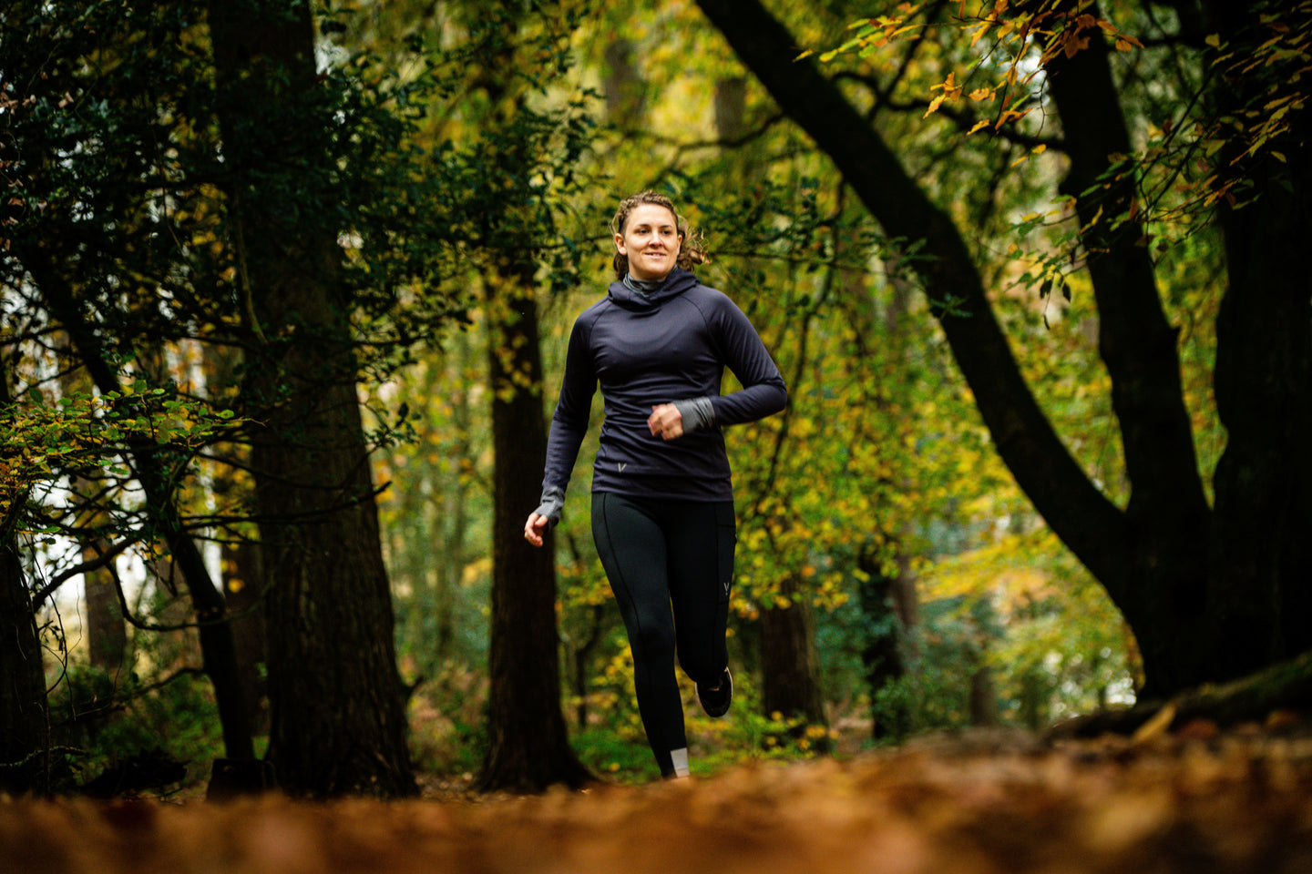 Person running through a forest