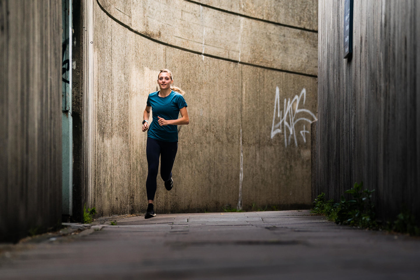 Woman running down a city street