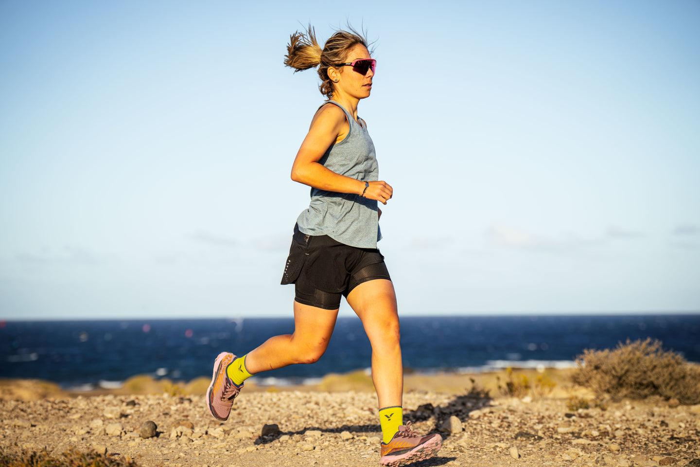Woman running on a coastal path